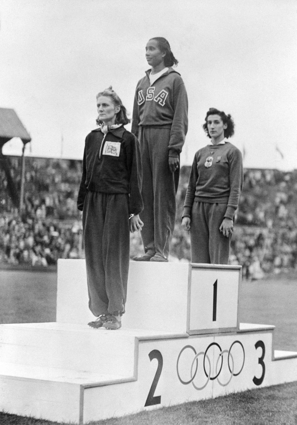 <p>1948 – ALICE COACHMAN – SPORTS – First African-American woman to win an Olympic gold medal. — Alice Coachman, (C) of the U.S. along with the winner D.J. Tyler, (L) of Great Britain, and M.O.M. Ostermeyer, of France, stand on a podium at Wembley Stadium in London, England, August 7, 1948, to receive their awards for the Olympic women’s high jump. (Bettmann/CORBIS) </p>