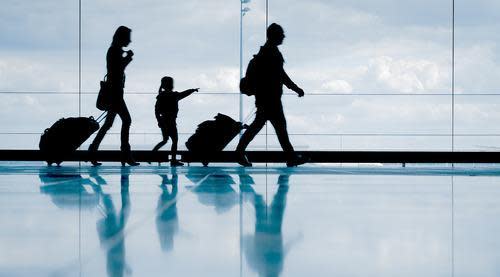 Family-walking-through-airport