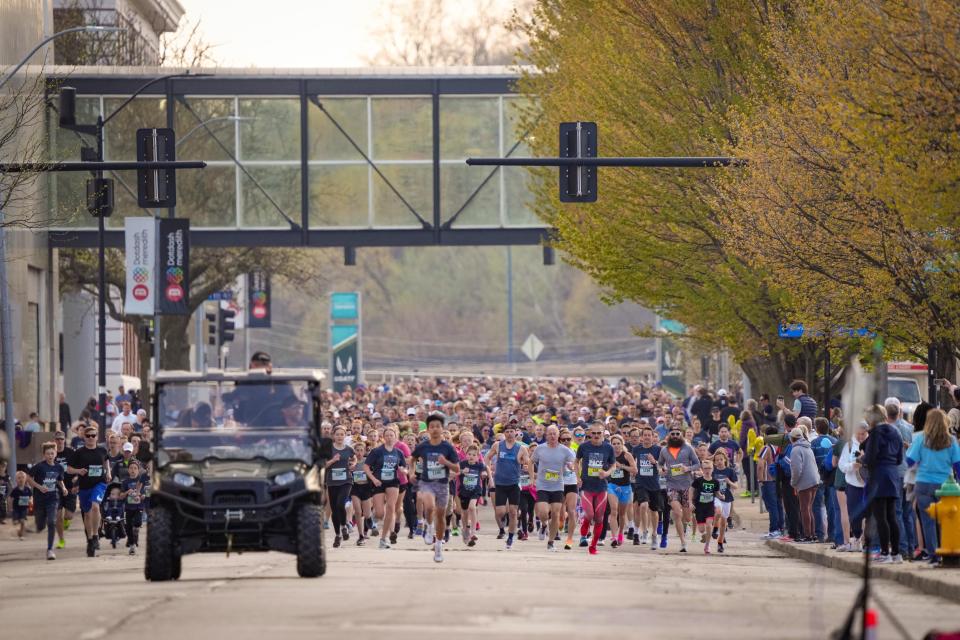 Runners participate in the recreational division of the 14th Annual Grand Blue Mile, Tuesday, April 25, 2023. 