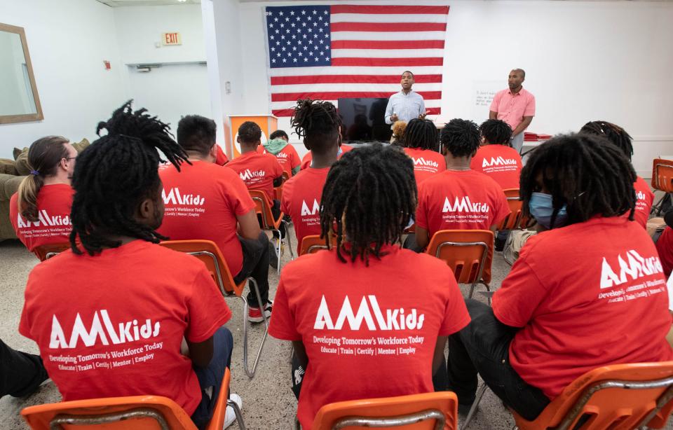 New executive director Pierre Cotton, top center, addresses the students during the daily large group meeting at AMIkids in Pensacola on Tuesday, Feb. 14, 2023.