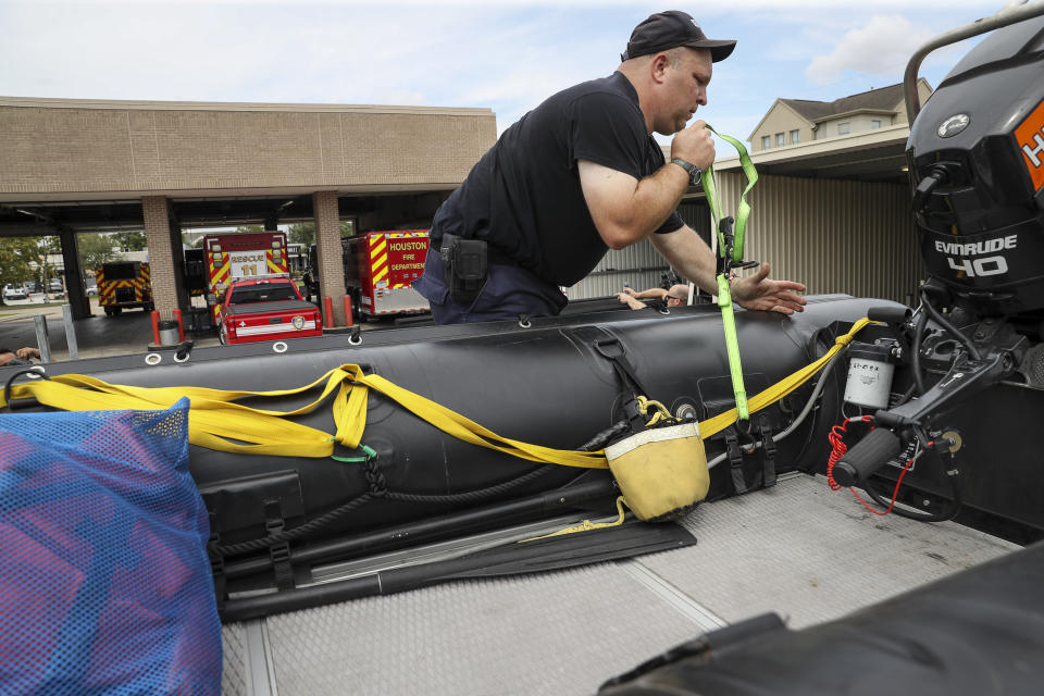 Houston Firefighter Paul Kessler prepares water-rescue equipment Monday, Aug. 24, 2020, at HFD Station 11 in Houston. Tropical weather systems are expected to hit Texas and Louisiana later in the week. (Jon Shapley/Houston Chronicle via AP)