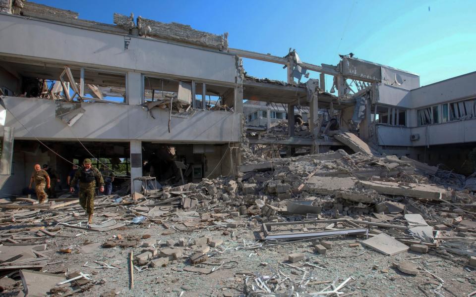 Police officers inspect a building of H.S. Skovoroda Kharkiv National Pedagogical University damaged by a Russian missile strike, as Russia's attack on Ukraine continues, in Kharkiv, Ukraine July 6, 2022 - Reuters