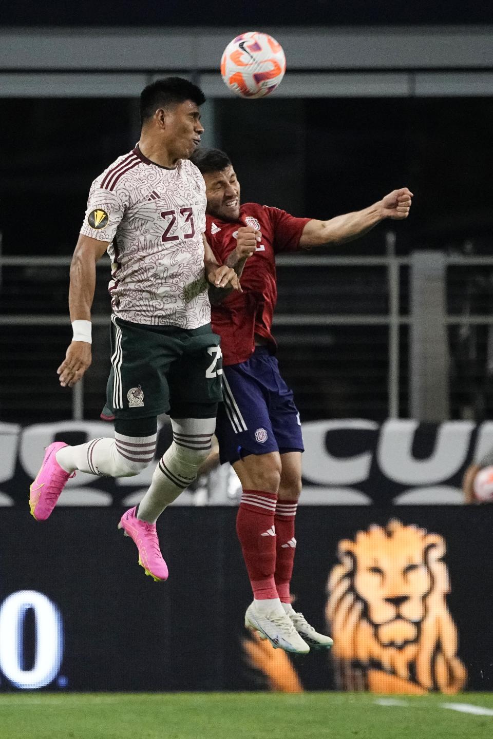 Mexico defender Jesús Gallardo (23) and Costa Rica defender Jefry Valverde go for a head ball during the first half of a CONCACAF Gold Cup soccer quarterfinal Saturday, July 8, 2023, in Arlington, Texas. (AP Photo/Sam Hodde)