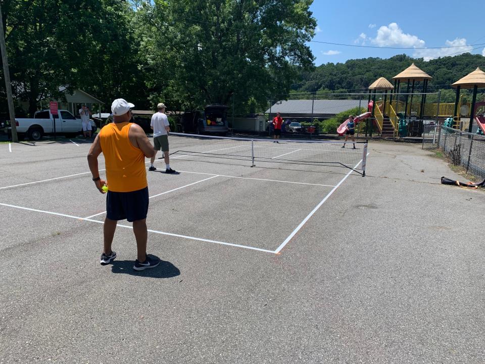 Volunteers with the Woodfin Parks and Greenways Advisory Committee and the community helped to convert a  portion of the parking lot at Woodfin’s Geneva Maney Park into pickleball courts following the launch of a Pickleball pilot program. August 2022.