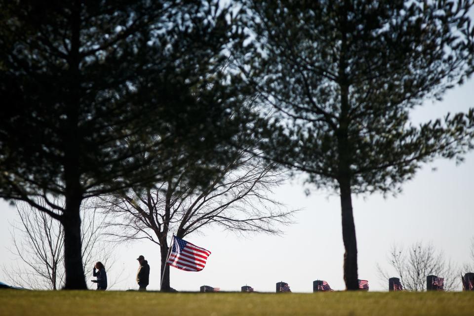 People visit loved ones buried at the Iowa Veterans Cemetery on Veterans Day in 2020. The cemetery will host the state's 2023 official Veterans Day observance at 10 a.m. Friday.