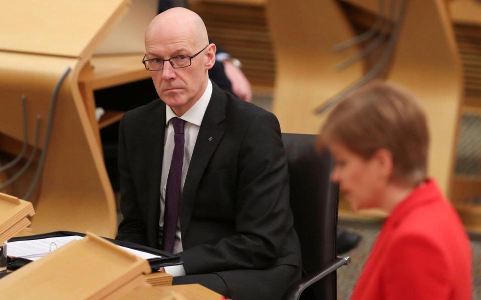John Swinney delivered the Scottish Government's daily Covid briefing - AFP
