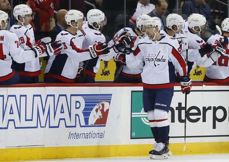 Mar 19, 2019; Newark, NJ, USA; Washington Capitals center Evgeny Kuznetsov (92) celebrates with teammates after scoring a goal against the New Jersey Devils during the second period at Prudential Center. Mandatory Credit: Noah K. Murray-USA TODAY Sports