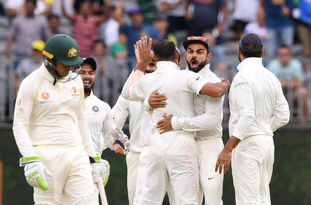 India's captain Virat Kohli celebrates with his teammates after the dismissal of Australia's Travis Head on day three of the second test match between Australia and India at Perth Stadium in Perth, Australia, December 16, 2018. AAP/Dave Hunt/via REUTERS