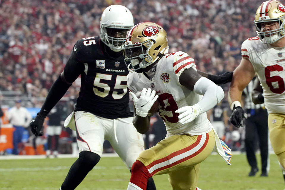 San Francisco 49ers wide receiver Deebo Samuel (19) scores a touchdown as Arizona Cardinals linebacker Chandler Jones (55) defends during the second half of an NFL football game, Sunday, Oct. 10, 2021, in Glendale, Ariz. (AP Photo/Darryl Webb)