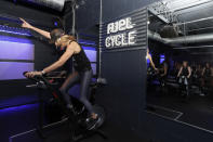 Fuel Training Studio owner Julie Bokat leads a spin class in a workout space inside the gym, Thursday, Jan. 19, 2023, in Newburyport, Mass. Gyms and fitness studios were among the hardest hit businesses during the pandemic. But for gyms who made it through the worst, signs of stability are afoot. (AP Photo/Mary Schwalm)