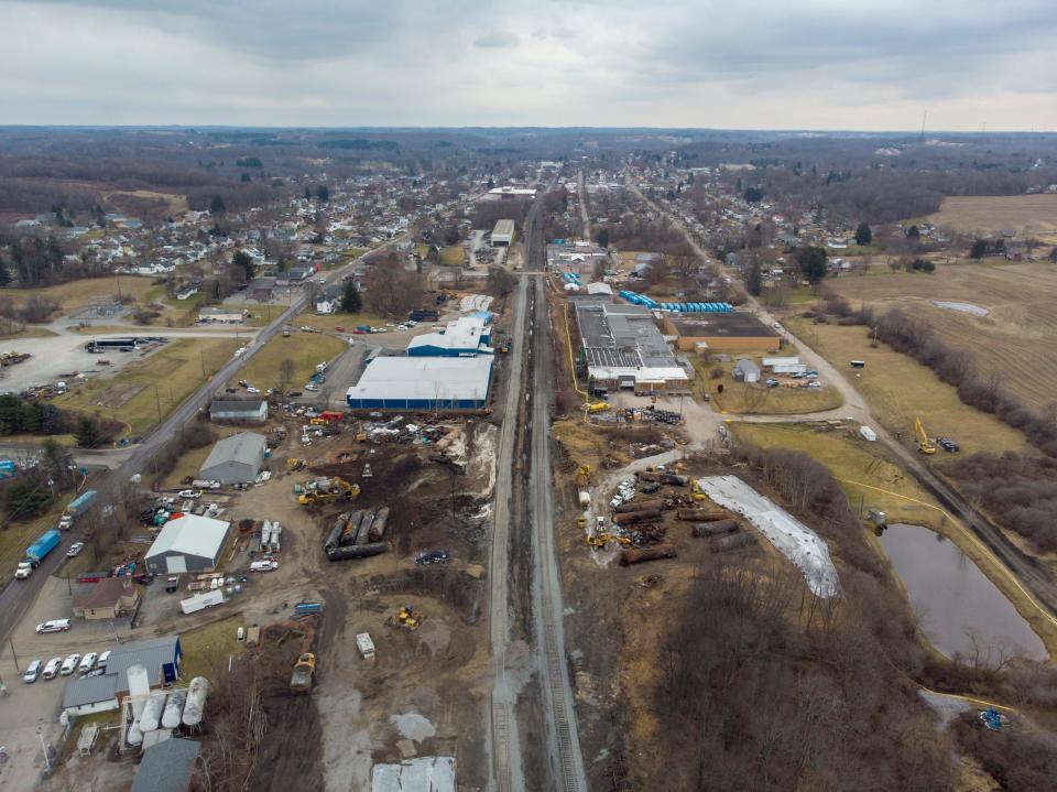 Feb 20, 2023; East Palestine, Ohio, USA;  The wreckage of the Norfolk Southern train derailment just a few blocks from downtown East Palestine can be seen being cleaned up. Mandatory Credit: Adam Cairns-The Columbus Dispatch