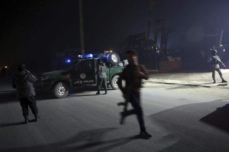 Policemen block the road near the site of a suicide attack in Kabul, Afghanistan, Monday, Jan. 14, 2019. Afghan officials say multiple people were killed when a suicide bomber detonated a vehicle full of explosive in the capital Kabul on Monday. (AP Photo/Massoud Hossaini)