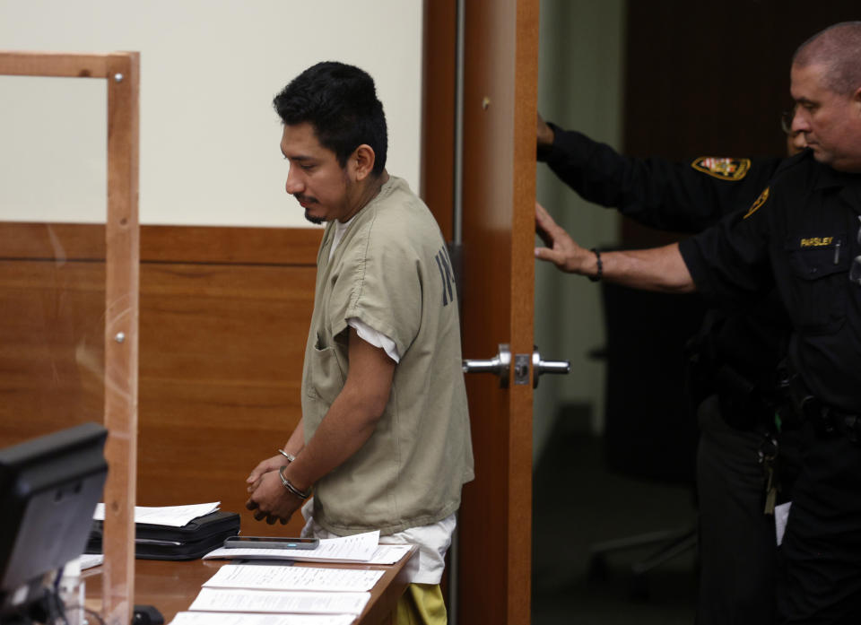Gerson Fuentes, left, the man accused of raping a 10-year-old girl who then traveled to Indiana to have an abortion, enters Franklin County common pleas court for his bond hearing in Columbus, Ohio, Thursday, July 28, 2022. Judge Julie Lynch denied bond. (AP Photo/Paul Vernon)