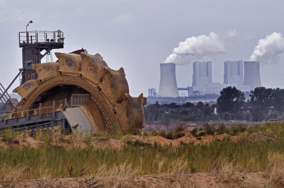 File--- In this photo taken Aug. 27, 2018 bucket wheel digs for coal near the Hambach Forest near Dueren, Germany. (AP Photo/Martin Meissner)