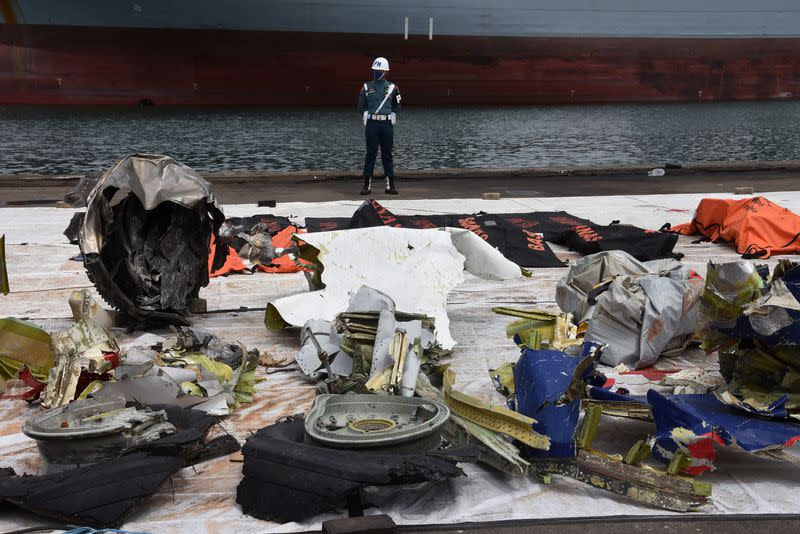 A member of the Indonesian navy personnel stands guard as the debris of Sriwijaya Air flight SJ 182, which crashed into the Java sea last week, are seen during a search and rescue operation at Tanjung Priok port in Jakarta