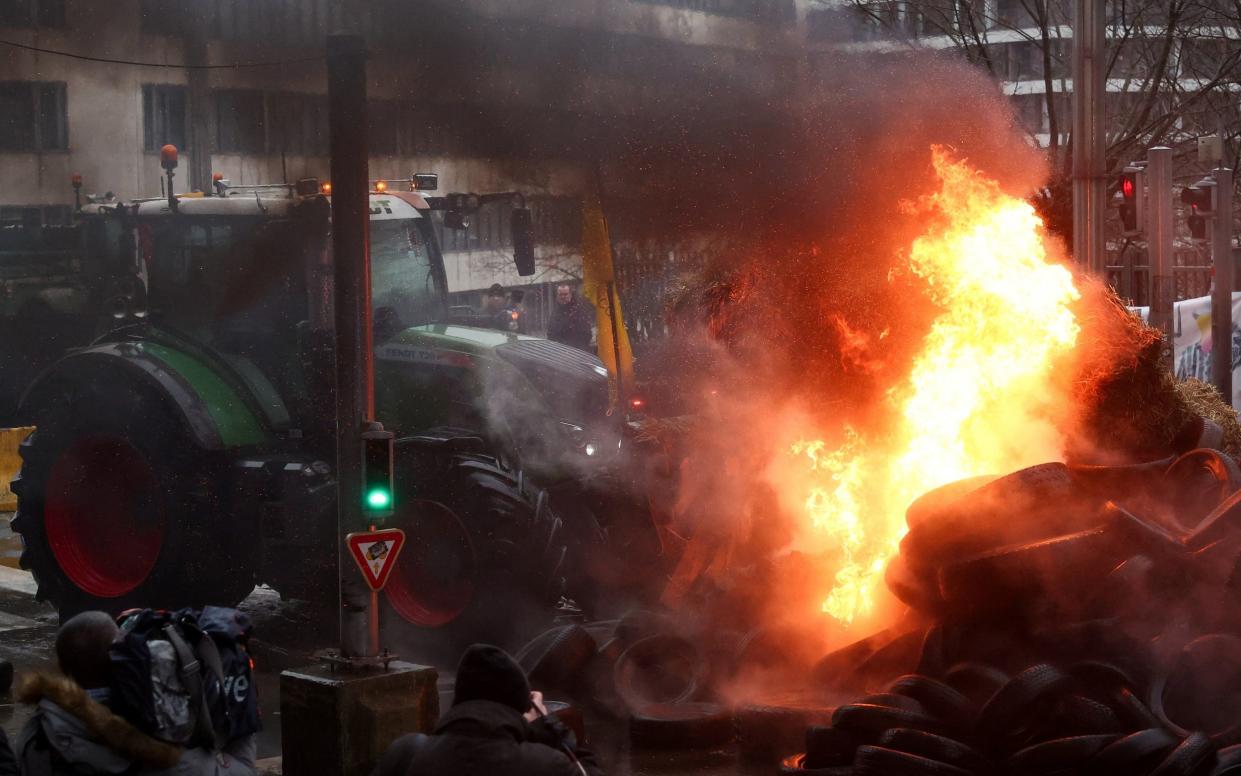 Mounds of burning tyres and hay bales were strewn across the Rue de la Loi