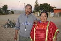 Gabino Bautista (L) and his wife Martha pose for a photograph in the neighborhood of New Copala in San Quintin, Mexico, November 19, 2015. REUTERS/Alasdair Baverstock