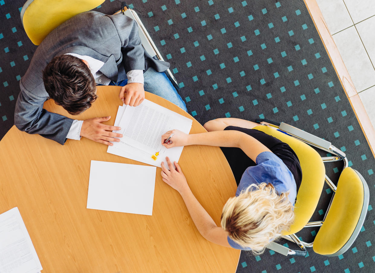 Bird's eye view of applicant and interviewer seated at a conference table