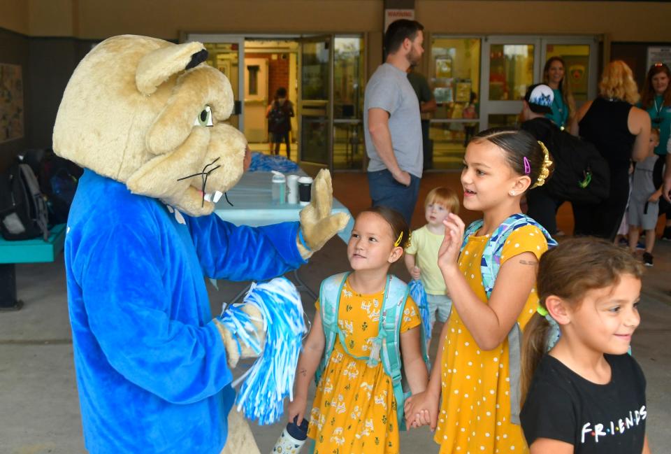 Buddy the Bobcat greets the kids after the Longleaf Elementary Walk to School Day in October 2022. About 200 students, parents, siblings, and staff took part in the event.