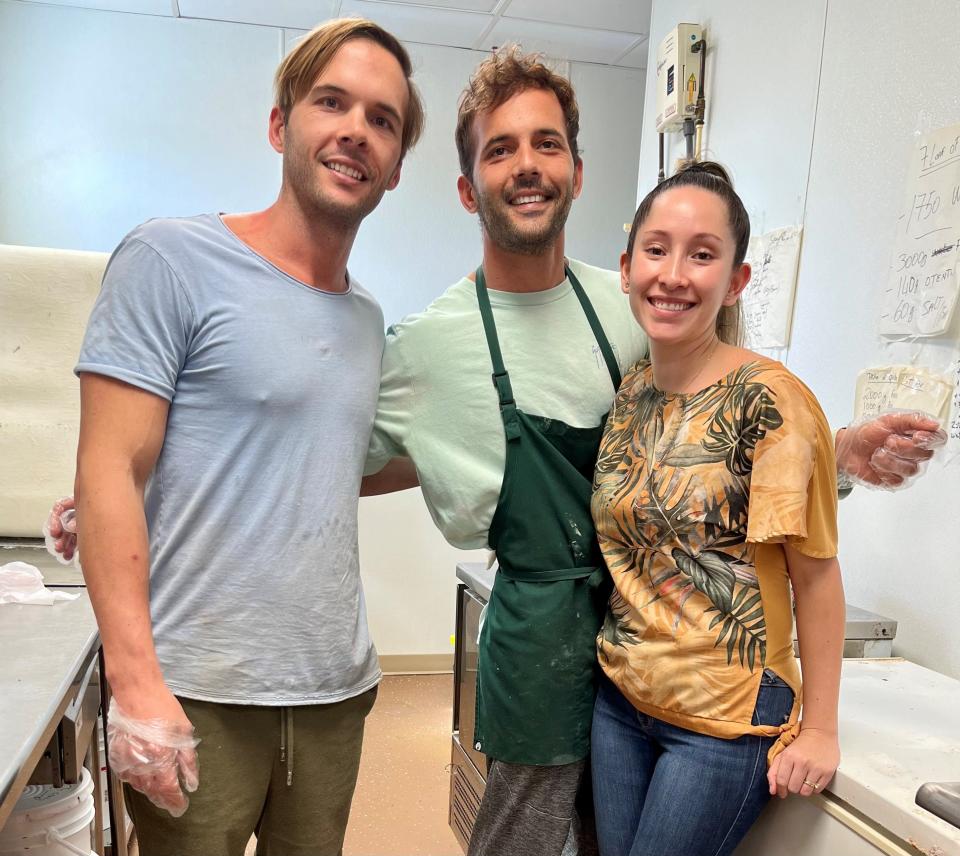 Adam Brunet, left, is pictured at Pine Island Getaway Cafe with his wife Keissy and his twin brother Florent.