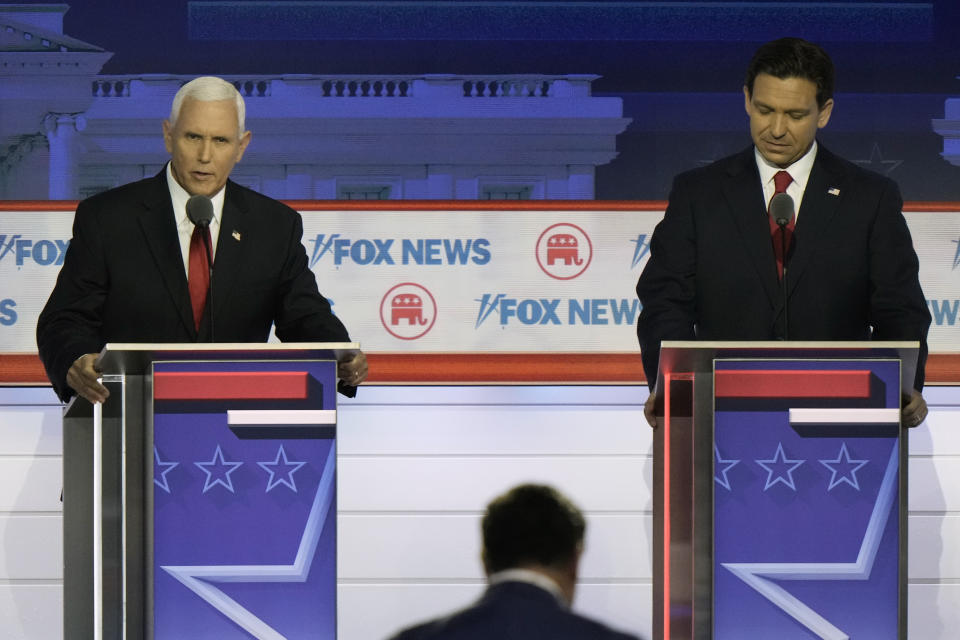 FILE - Former Vice President Mike Pence speaks as Florida Gov. Ron DeSantis listens during a Republican presidential primary debate hosted by FOX News Channel Wednesday, Aug. 23, 2023, in Milwaukee. (AP Photo/Morry Gash, File)