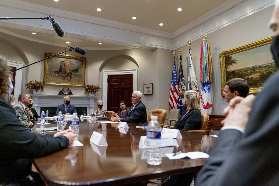 Vice President Mike Pence, center, accompanied by Administrator of the Centers for Medicare and Medicaid Services Seema Verma, center left, participates in a meeting on safety and quality for nursing homes in the Roosevelt Room of the White House, Thursday, Sept. 17, 2020, in Washington. (AP Photo/Andrew Harnik)