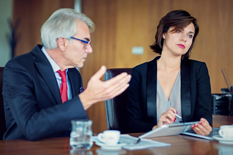 a male co-worker talking to a woman co-worker