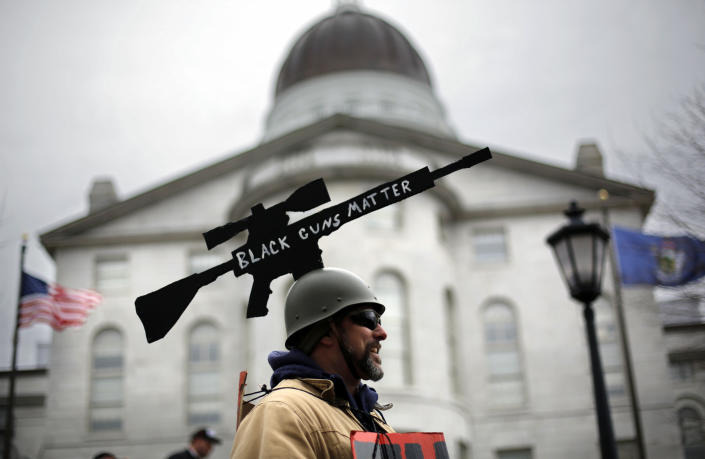 <p>Joe Dobbins of Hartford, Maine, wears a cut-out of an AR-10 tactical rifle while attending a gun rights rally, Saturday, April 14, 2018, at the State House in Augusta, Maine. (Photo: Robert F. Bukaty/AP) </p>