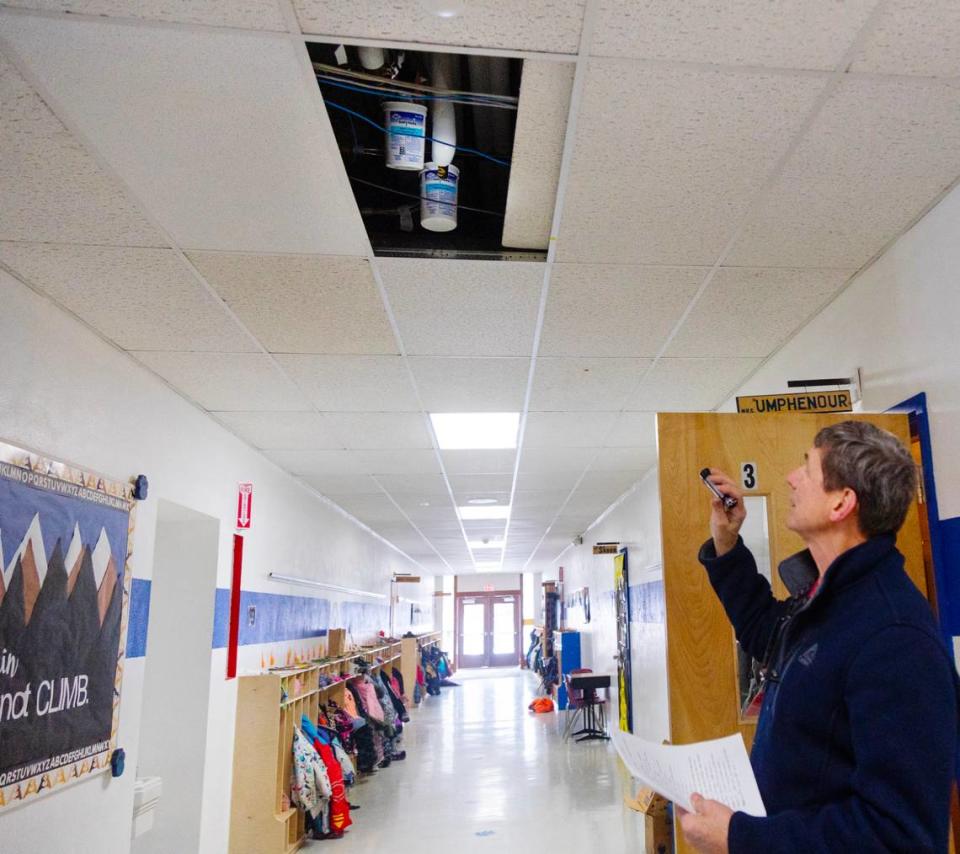 Two buckets hang inside the ceiling at Valley View to collect water from leaking pipes.