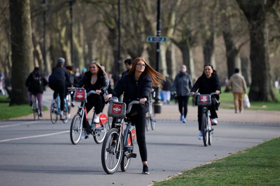 People cycle on hire bicycles in Hyde Park in central London  (AFP via Getty Images)