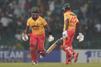 Zimbabwe's Luke Jongwe, left, and Clive Madande celebrate their win in the second Twenty20 cricket match between Sri Lanka and Zimbabwe in Colombo, Sri Lanka, Tuesday, Jan. 16, 2024. (AP Photo/Eranga Jayawardena)