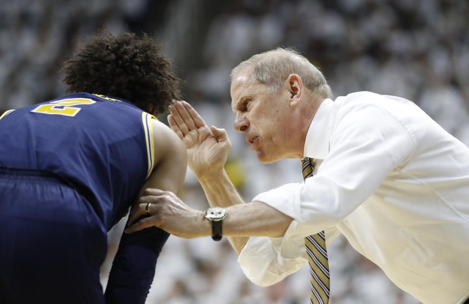 Michigan coach John Beilein talks with guard Jordan Poole during the first half of the team's NCAA college basketball game against Michigan State, Saturday, March 9, 2019, in East Lansing, Mich. (AP Photo/Carlos Osorio)