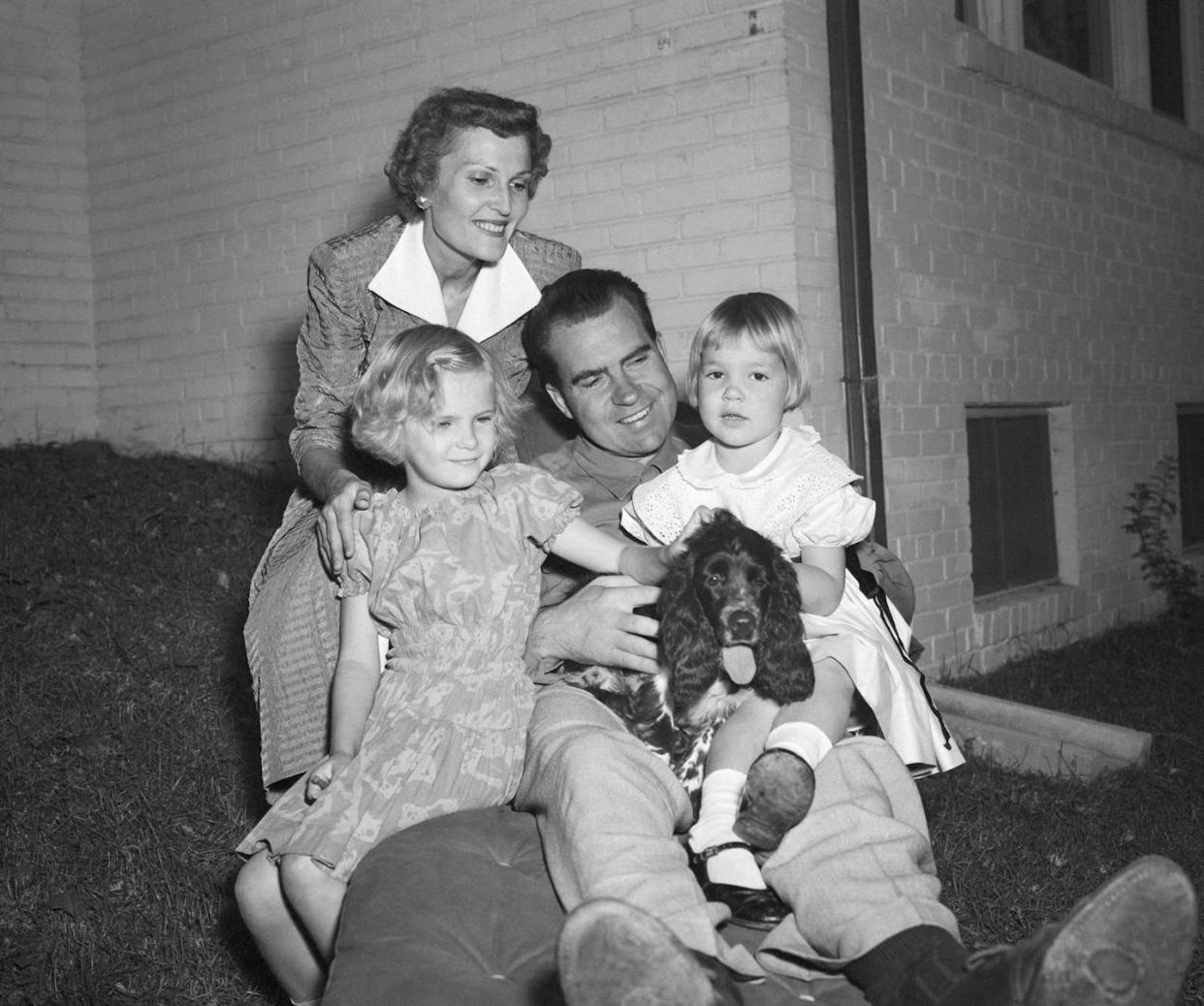 Richard Nixon poses with his family and their dog, Checkers, in Washington, D.C., in September 1952. <a href="https://www.gettyimages.com/detail/news-photo/washington-dc-senator-richard-nixon-of-california-takes-news-photo/514704612?adppopup=true" rel="nofollow noopener" target="_blank" data-ylk="slk:Bettmann/Contributor;elm:context_link;itc:0;sec:content-canvas" class="link ">Bettmann/Contributor </a>