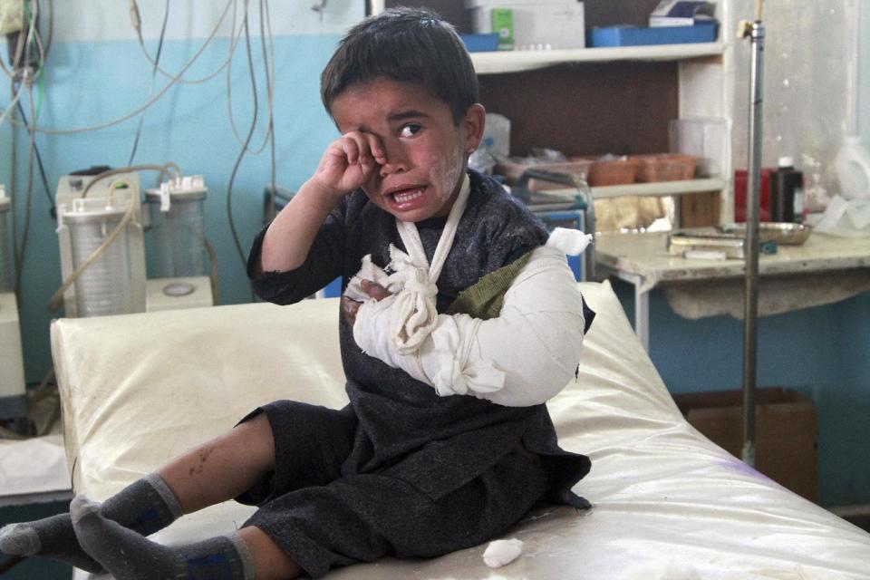 An injured boy sits on a bed following an attack, at a hospital in Ghazni city, Afghanistan, Monday, May 12, 2014. The attacks happened on the outskirts of the city, said deputy provincial governor, Mohammad Ali Ahmadi. Two women and a policeman were killed, while two policemen and six civilians, including three children, were wounded, added Ahmadi. (AP Photo/Rahmatullah Nikzad)