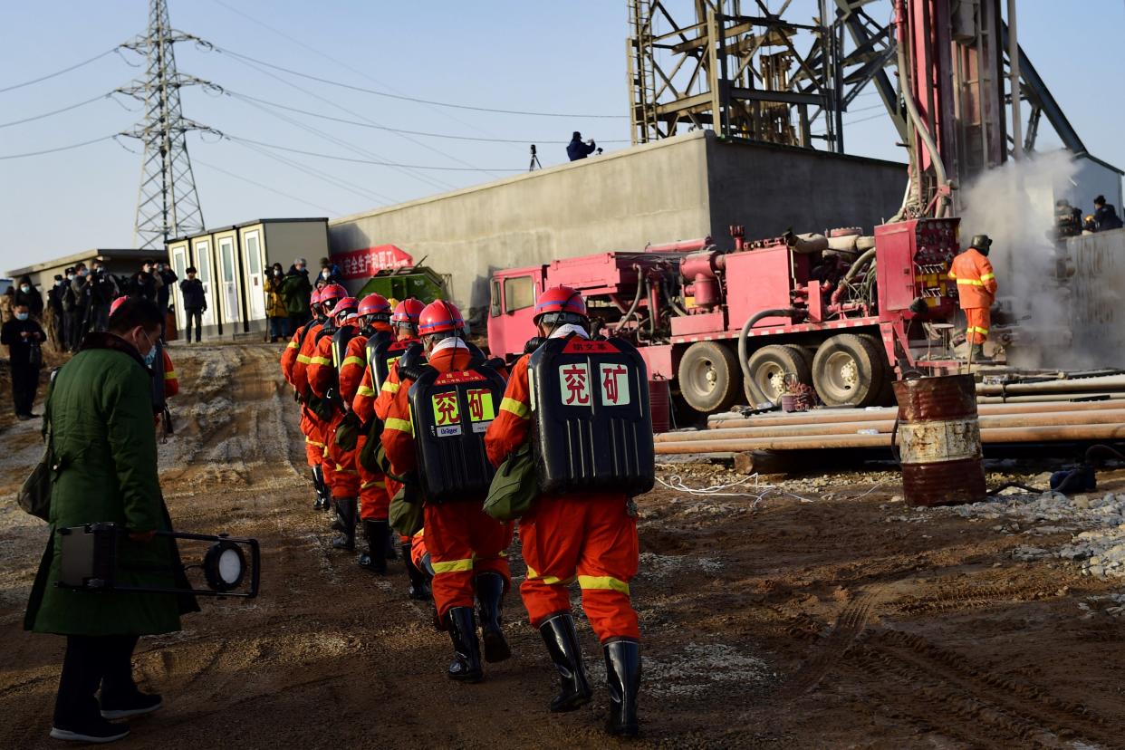 Rescuers working at the site of gold mine explosion where 22 miners were trapped underground in Qixia (AFP via Getty Images)