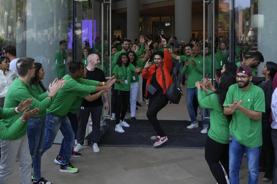 Apple retail employees applaud as they welcome customers during the opening of the first Apple Inc. flagship store in Mumbai, India, Tuesday, April 18, 2023. Apple Inc. opened its first flagship store in India in a much-anticipated launch Tuesday that highlights the company’s growing aspirations to expand in the country it also hopes to turn into a potential manufacturing hub. (AP Photo/Rafiq Maqbool)