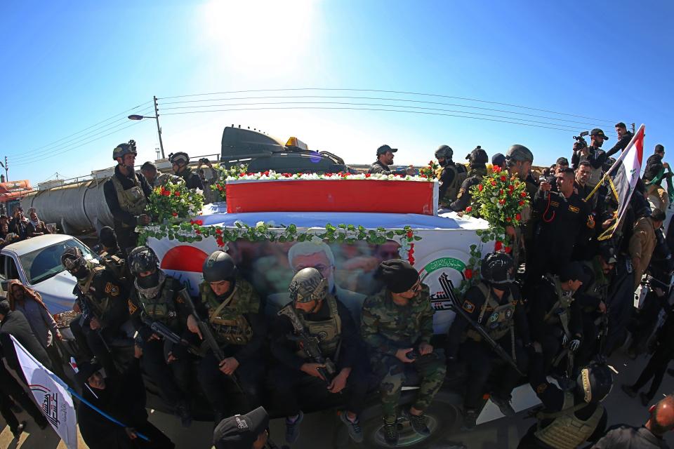 Mourners escort the flag-draped coffin of Abu Mahdi al-Muhandis, deputy commander of Iran-backed militias during his funeral procession in Basra, Iraq, Tuesday, Jan. 7, 2020. Thousands of people gathered in Basra on Tuesday to bid farewell to Abu Mahdi al-Muhandis, a senior Iraqi militia commander who was killed in a US airstrike on Friday. (AP Photo)