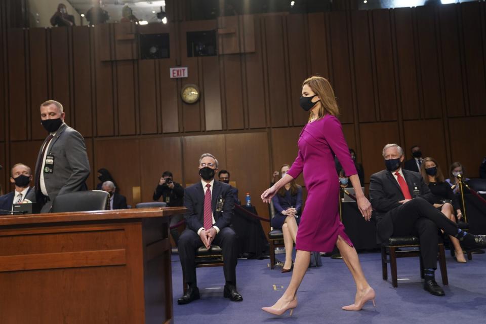 Amy Coney Barrett walks to her seat before the confirmation hearing.