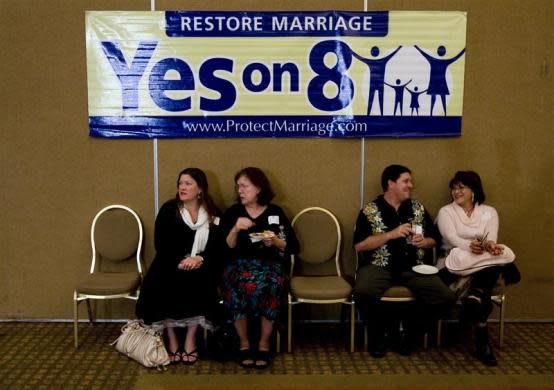 (L-R) Vivi Morris, Mary Morris, Alex Case and Ninie Case talk under a "Yes on 8'' sign at a pro Proposition 8 election party in Irvine, California November 4, 2008.