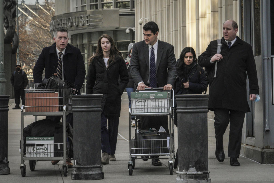 The prosecution team leaves Brooklyn Federal Court after winning a guilty verdict against Ruslan Maratovich Asainov, a former New York stock broker charged with becoming a sniper and trainer for the extremist Islamic State group in Syria and Iraq, Tuesday, Feb. 7, 2023, in New York. (AP Photo/Bebeto Matthews)