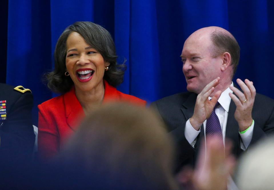 U.S. Rep. Lisa Blunt Rochester laughs with U.S. Sen. Chris Coons during an event promoting veterans' health benefits at the Major Joseph R. "Beau" Biden III National Guard/Reserve Center near New Castle, Friday, Dec. 16, 2022.