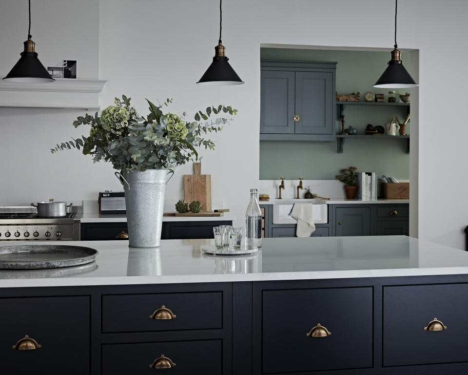 <p> OK... so black and navy shouldn&apos;t usually mix, but we&apos;re willing to make exceptions where kitchens look this cool. Situated around the island, these lights sit atop the Haddon shaker-style kitchen from Burbidge &amp; Son&apos;s Kitchen Makers for a sophisticated look. </p> <p> What makes this kitchen lighting idea smart is the fact that the brass fixture matches with the handles on the dark blue unit. </p>