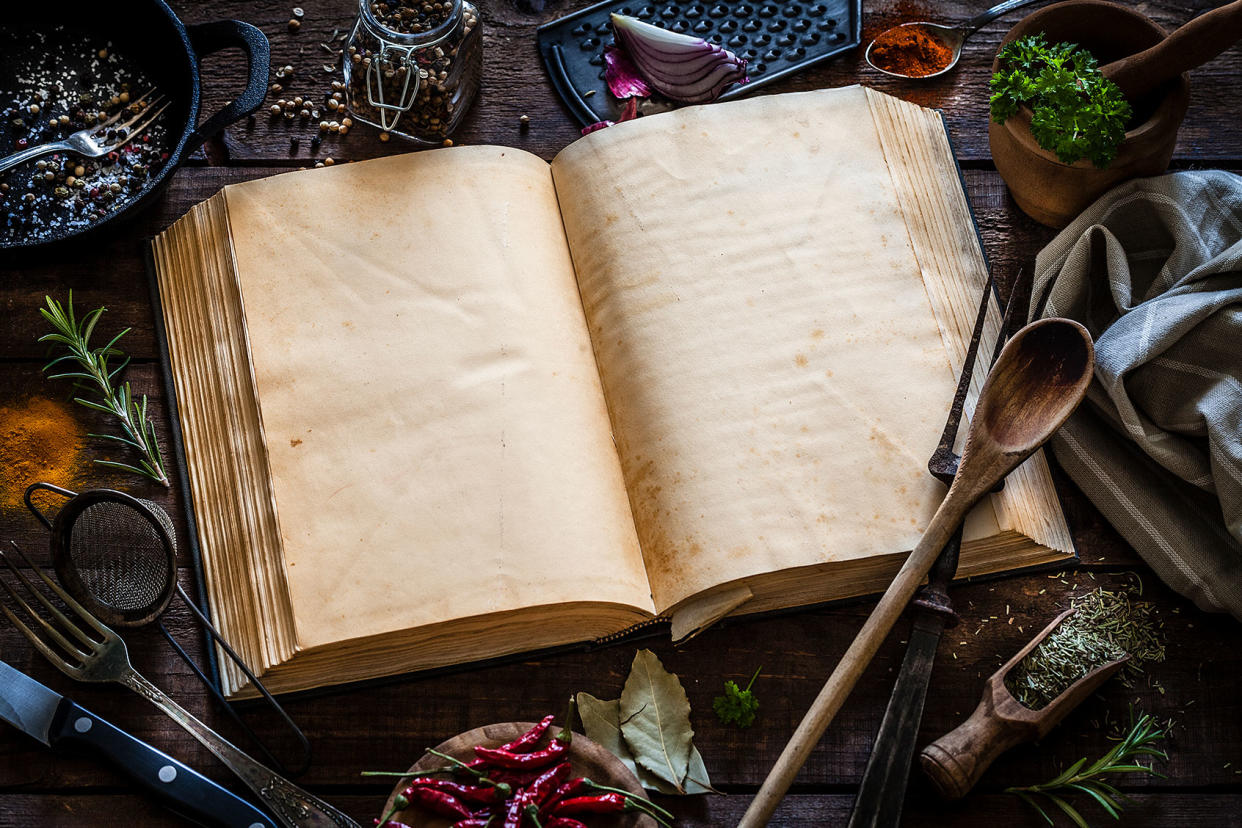 Vintage cookbook with kitchen utensils Getty Images/fcafotodigital