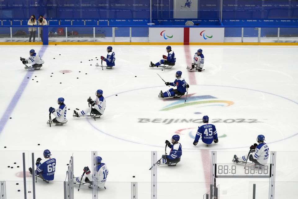 Slovakian hockey players take to the ice during a practice session at the 2022 Winter Paralympics in Beijing, Thursday, March 3, 2022. (AP Photo/Andy Wong)