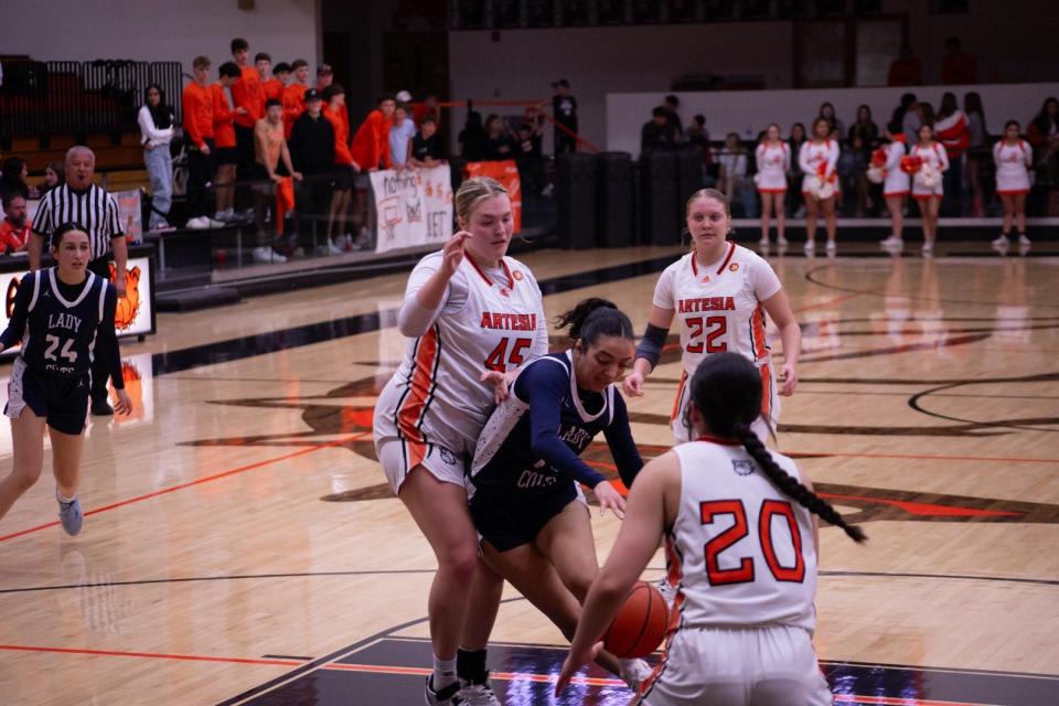 Artesia's Lorin Wagner (left) attempts to stop a Silver High Fighting Colt along with Kailee Padilla as Jenna Whitmire looks on during the opening round of the girls' 4A state basketball tournament in Artesia on March 8, 2024.