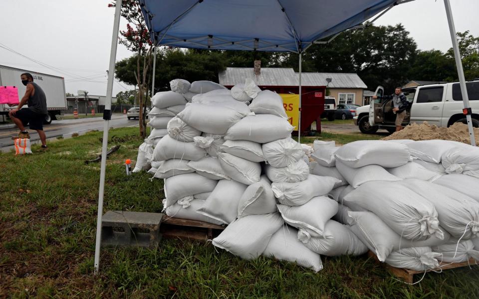 A man sells sand bags in Wilmington, North Carolina as residents braced for the arrival of Hurricane Isaias -  Gerry Broome/AP