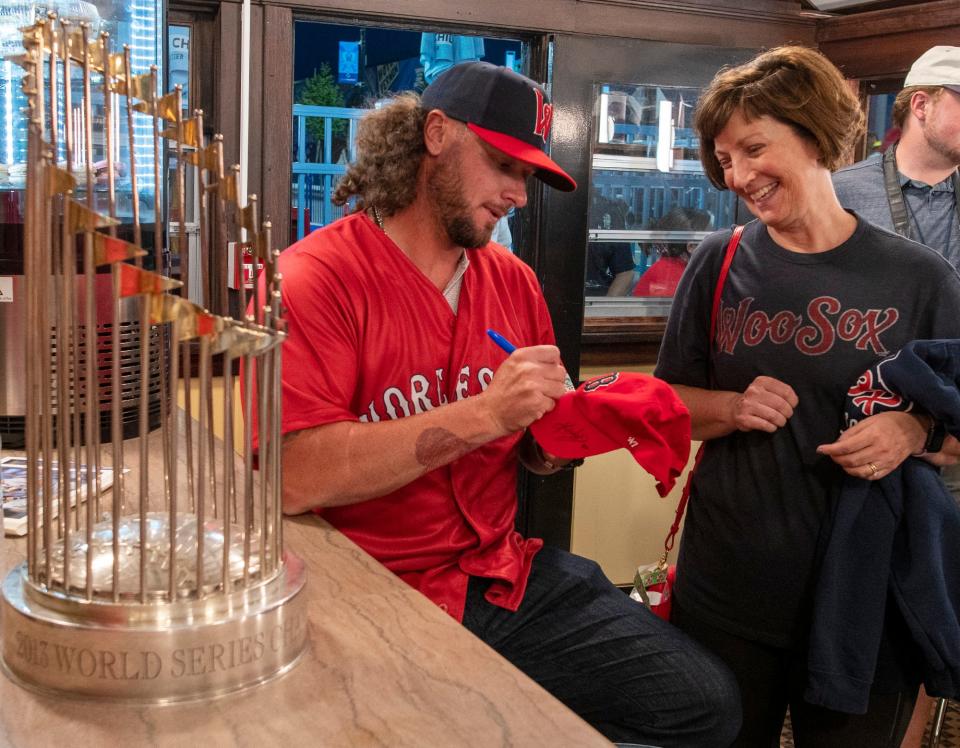 Former Red Sox star Jarrod Saltalamacchia signs a hat for Lynne Atkinson of Westborough Tuesday night at Polar Park.