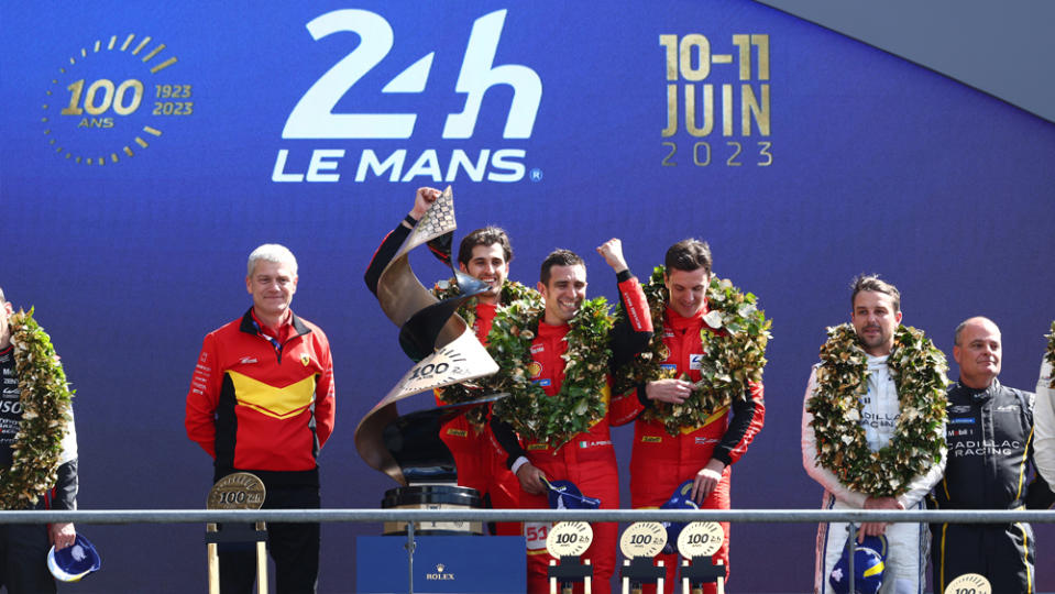 From left, Ferrari's 499P head Antonello Coletta and drivers Antonio Giovinazzi, Alessandro Pier Guidi, and James Calado bask in the podium's glow of victory at the 2023 24 Hours of Le Mans.