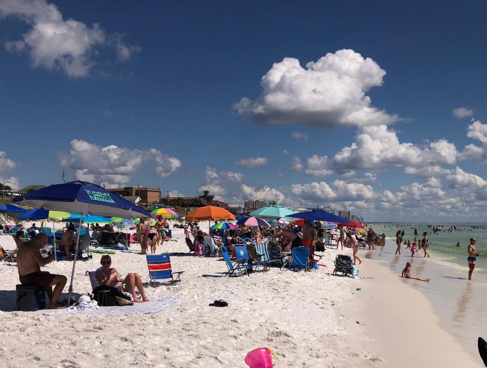 Beachgoers enjoy a recent sunny day at the beach along Scenic Gulf Drive in southern Walton County. A Wisconsin-based destination marketing consulting firm is working with the county's Tourist Development Council on a new three-year strategic plan.