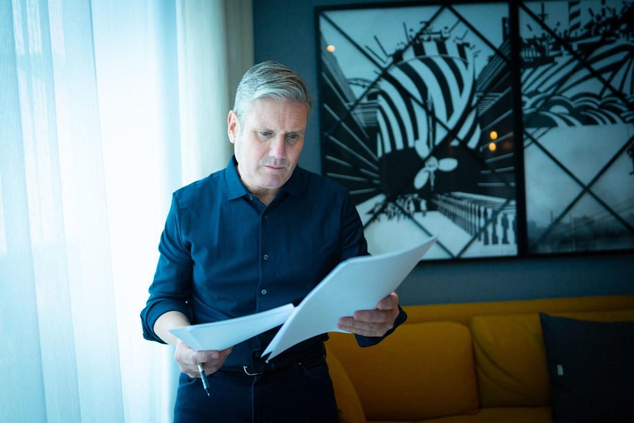 Keir Starmer poses for a photograph in his hotel room, as he prepares his keynote speech.